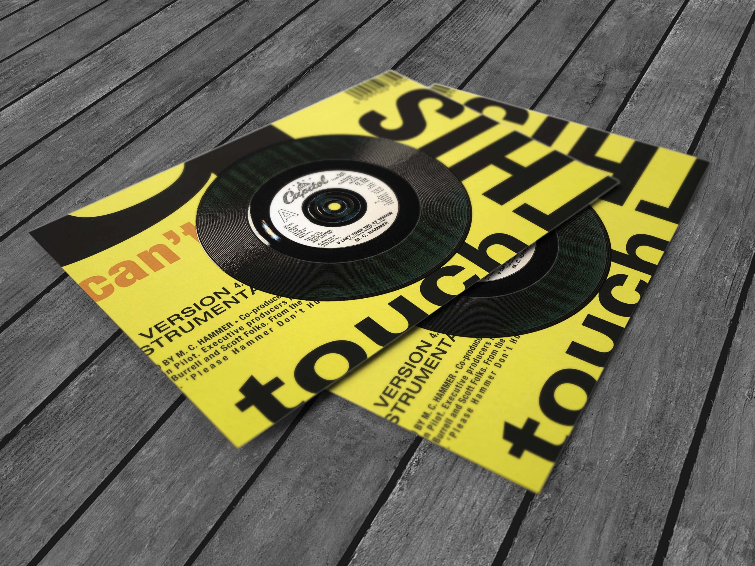 Two yellow records, made by Ricoh Touch. With a wooden backgrounde