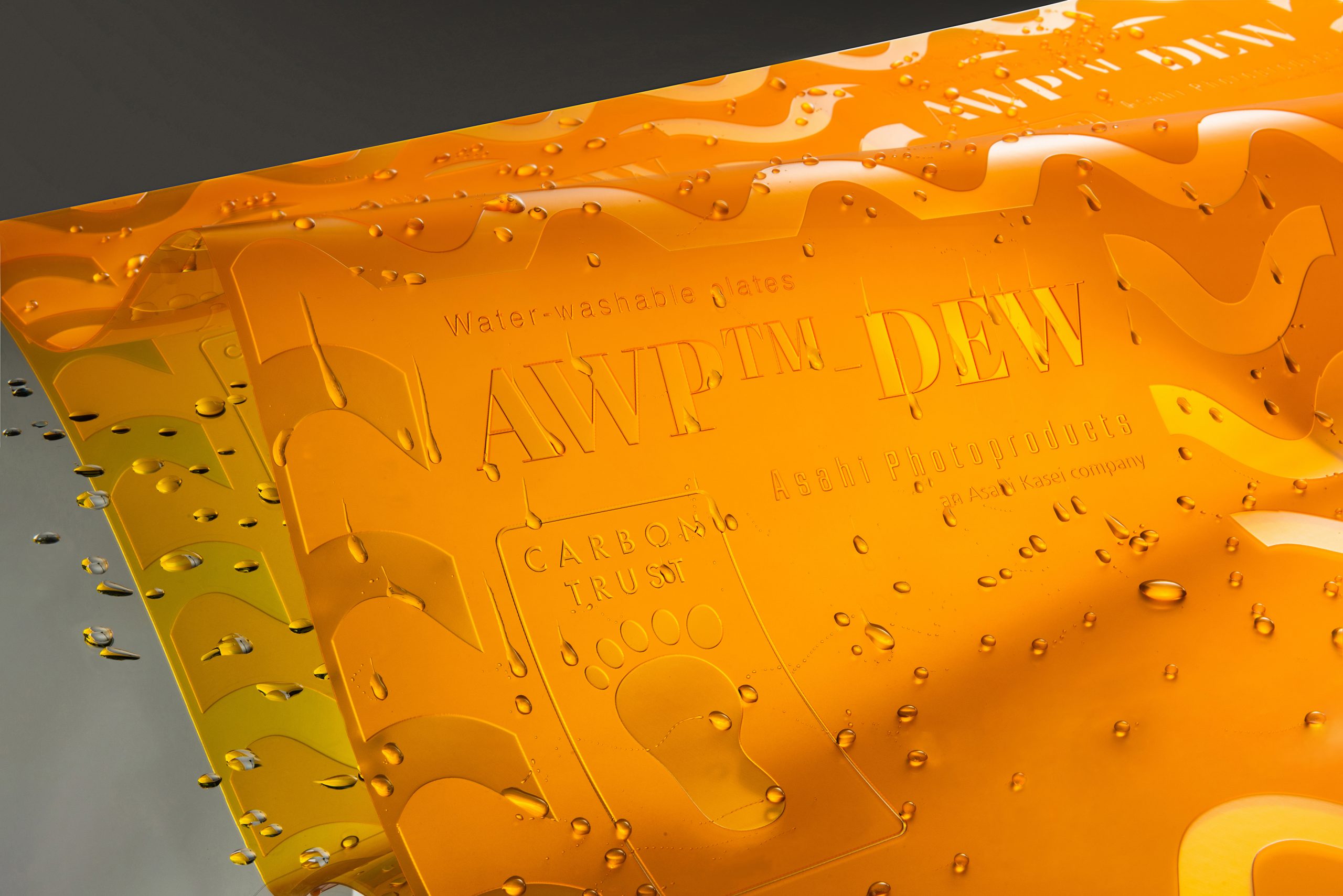 Orange plate of the Asahi AWP DEW - with a wave and drops of water